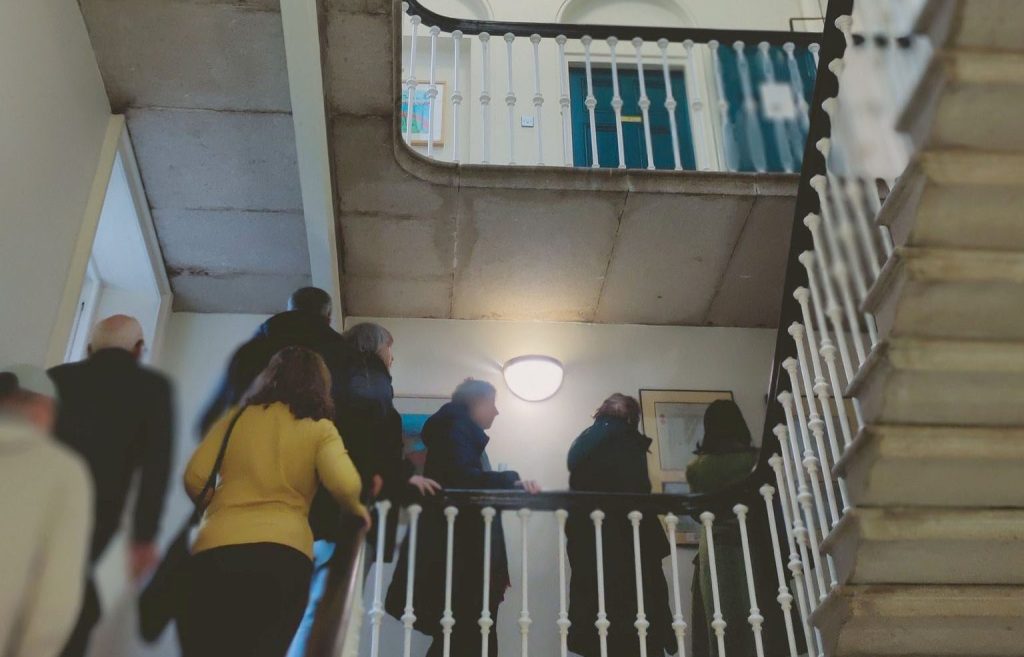 Group f people going up through stairs at Registry of Deeds office