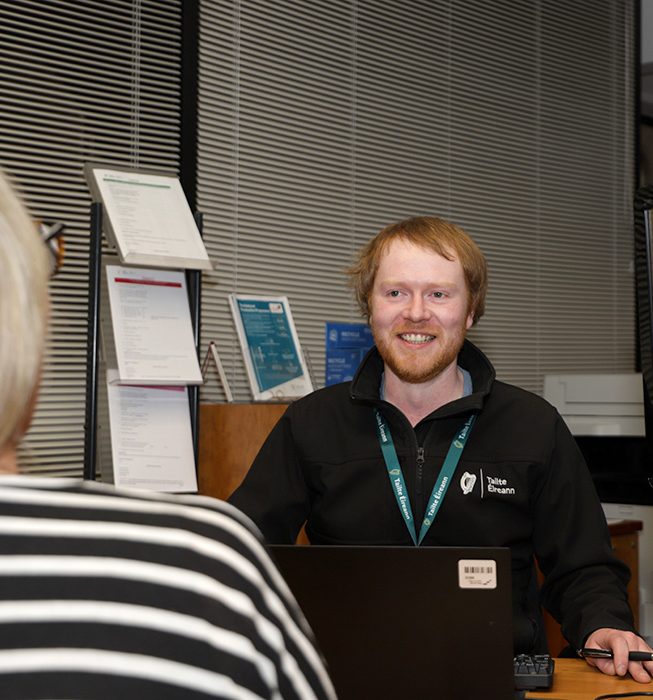 Staff Member assisting a Customer